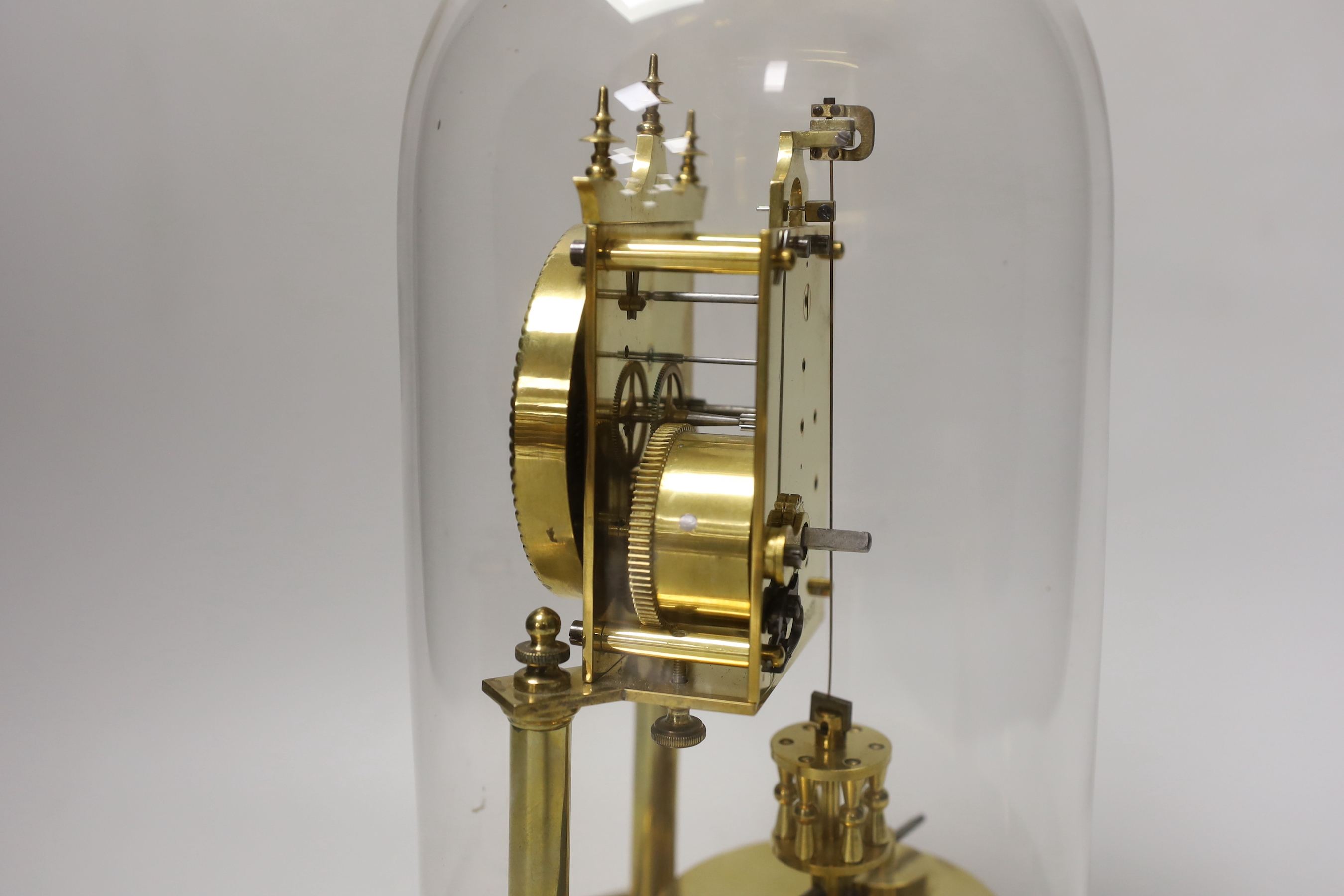 An early 20th century clock under glass dome, 29cm